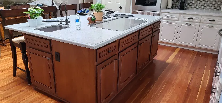 Kitchen with mahogany-stained island cabinetry and refinished hardwood floors